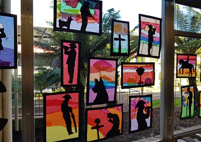 Brightly coloured artwork on the classroom window with silhouettes of ANZAC symbols